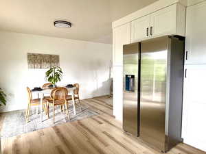 Spacious dining area with fresh paint, new flooring and lighting - open to living room