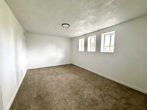Large family room with fresh paint, new carpet, and new windows