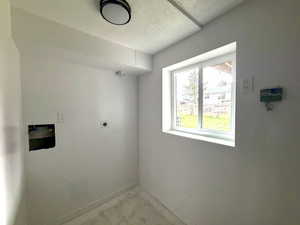 Downstairs laundry area in large mostly finished space