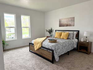 Large main floor primary bedroom with fresh paint, new carpet, 2 closets, and new windows