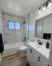 ALL NEW main floor bathroom with fresh paint, flooring, large profile wall tiles, vanity, mirror, lighting, and fixtures