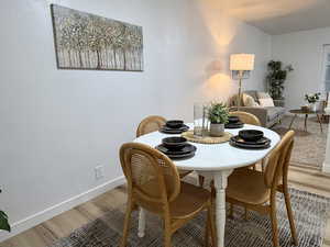 Spacious dining area with fresh paint, new flooring and lighting - open to living room