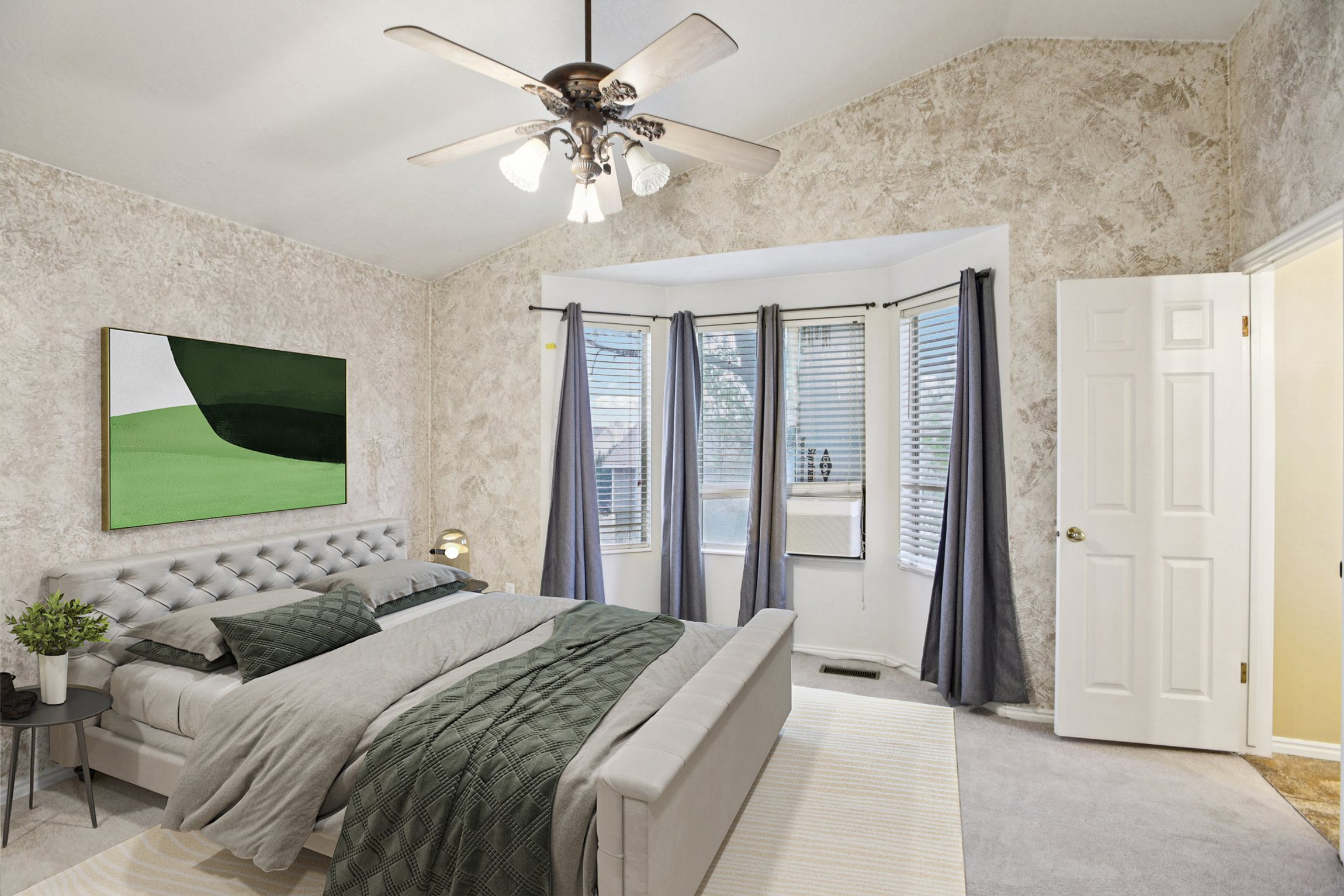 Bedroom with vaulted ceiling, light carpet, ceiling fan, and wallpapered walls