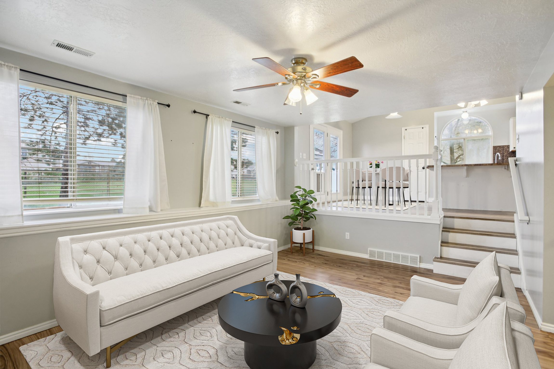 Sitting room with wood finished floors, ceiling fan, and a textured ceiling
