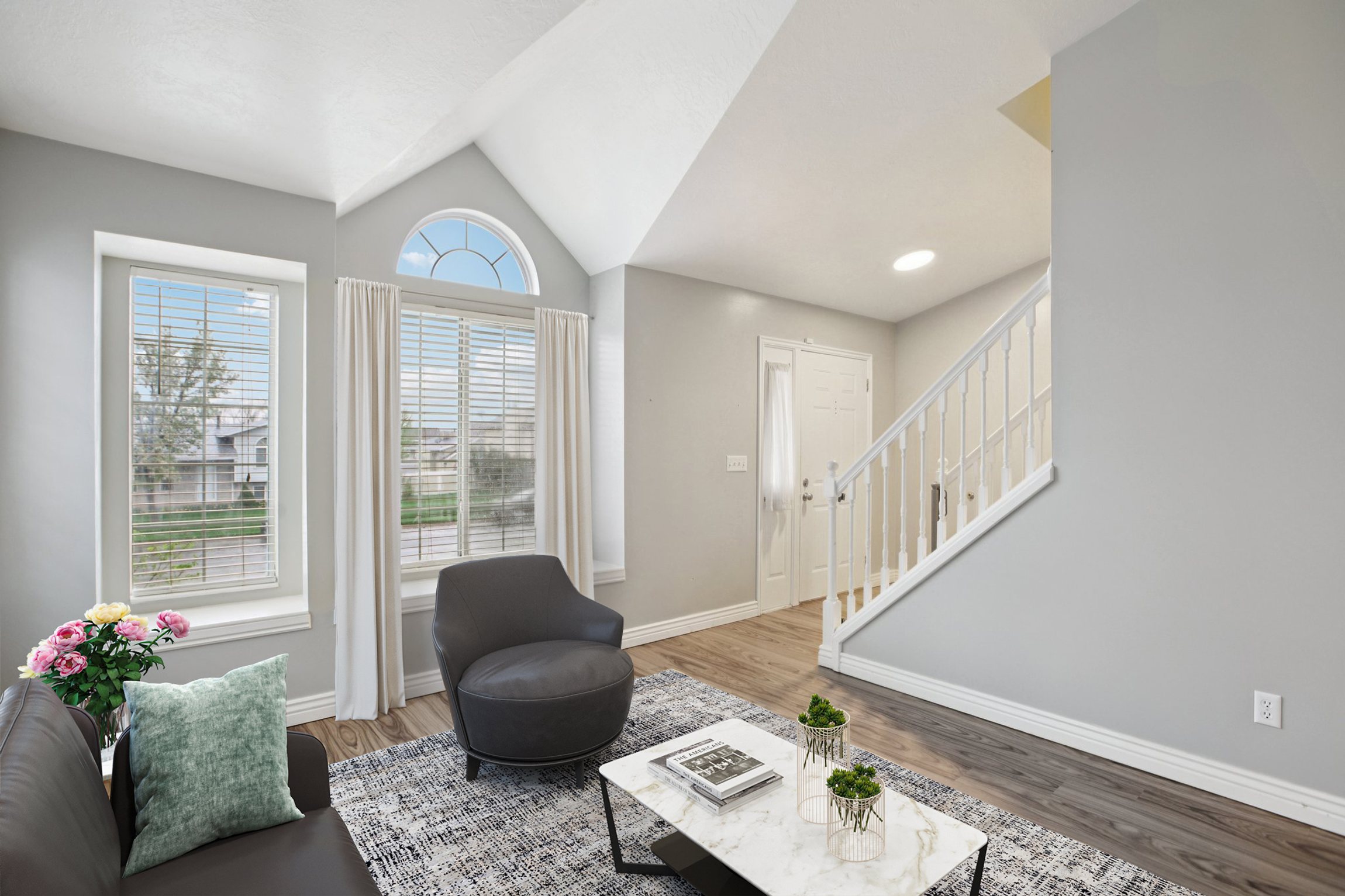 Living room with light wood-style flooring and lofted ceiling