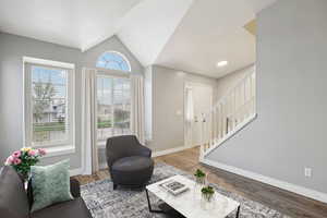 Living room with light wood-style flooring and lofted ceiling
