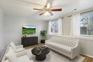 Sitting room with light wood-style flooring and ceiling fan