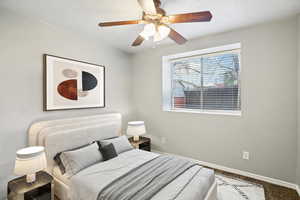 Bedroom with ceiling fan and baseboards
