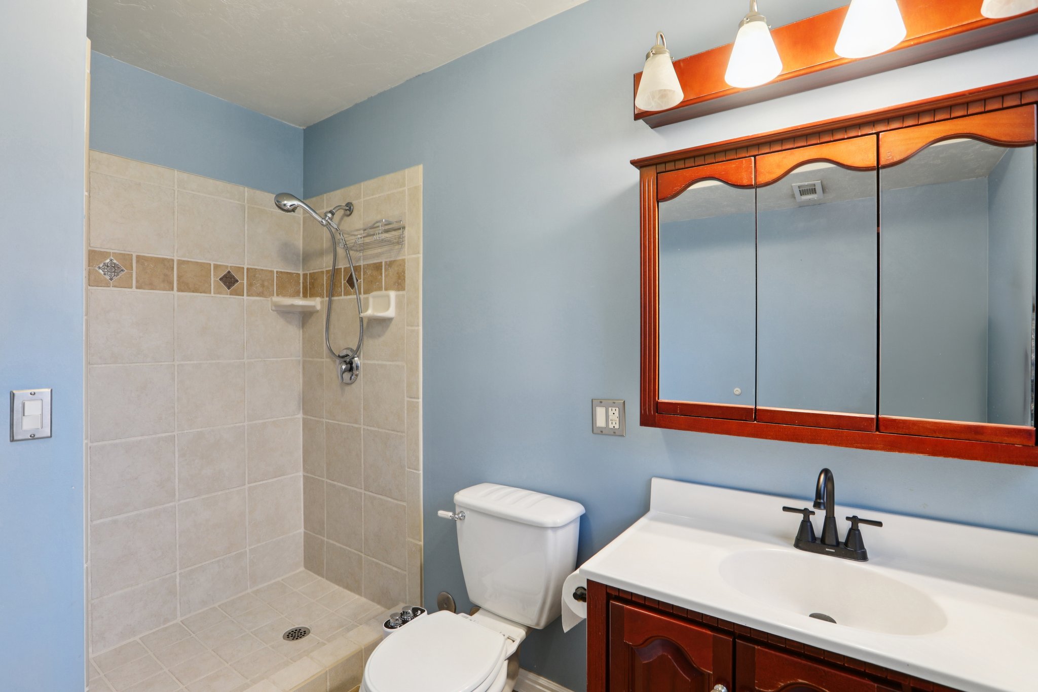 Bathroom with vanity and a shower stall