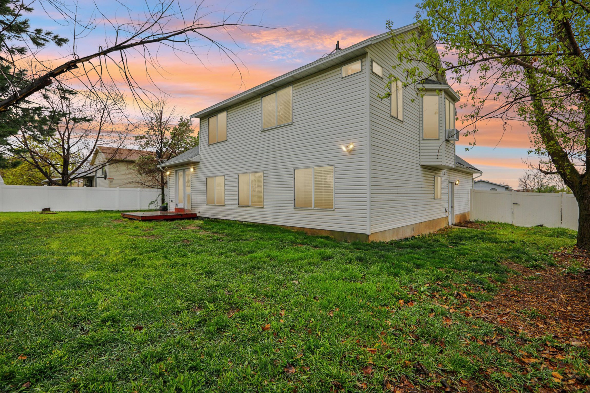 Rear view of property with a fenced backyard