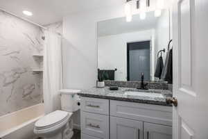 Full bath with vanity, shower / bathtub combination with curtain, and recessed lighting