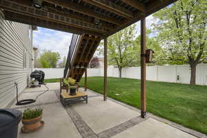 Fenced backyard featuring a patio area and area for grilling