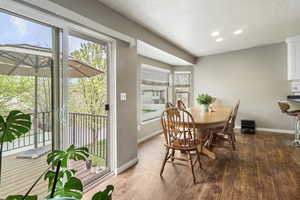 Dining space featuring wood finished floors, recessed lighting, and a textured ceiling