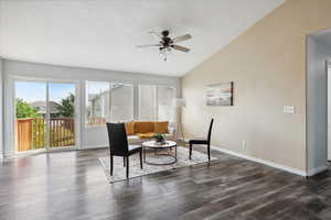 Living area with ceiling fan and dark wood-type flooring