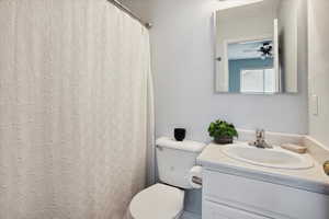 Bathroom featuring curtained shower and vanity
