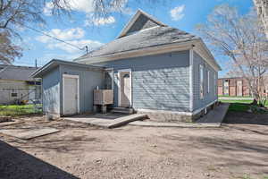 Back of house with roof with shingles and entry steps