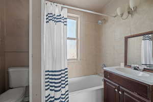 Bathroom with vanity and shower / bathtub combination with curtain
