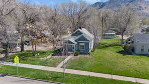 View of front of property featuring a front lawn and a chimney