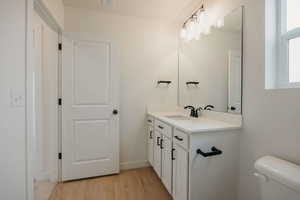 Bathroom featuring vanity and light wood-style floors