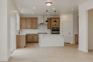 Kitchen featuring a kitchen bar, decorative light fixtures, wood finish cabinetry, a center island, and double oven