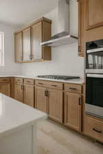 Kitchen with stainless steel appliances, light countertops, and light wood-type flooring