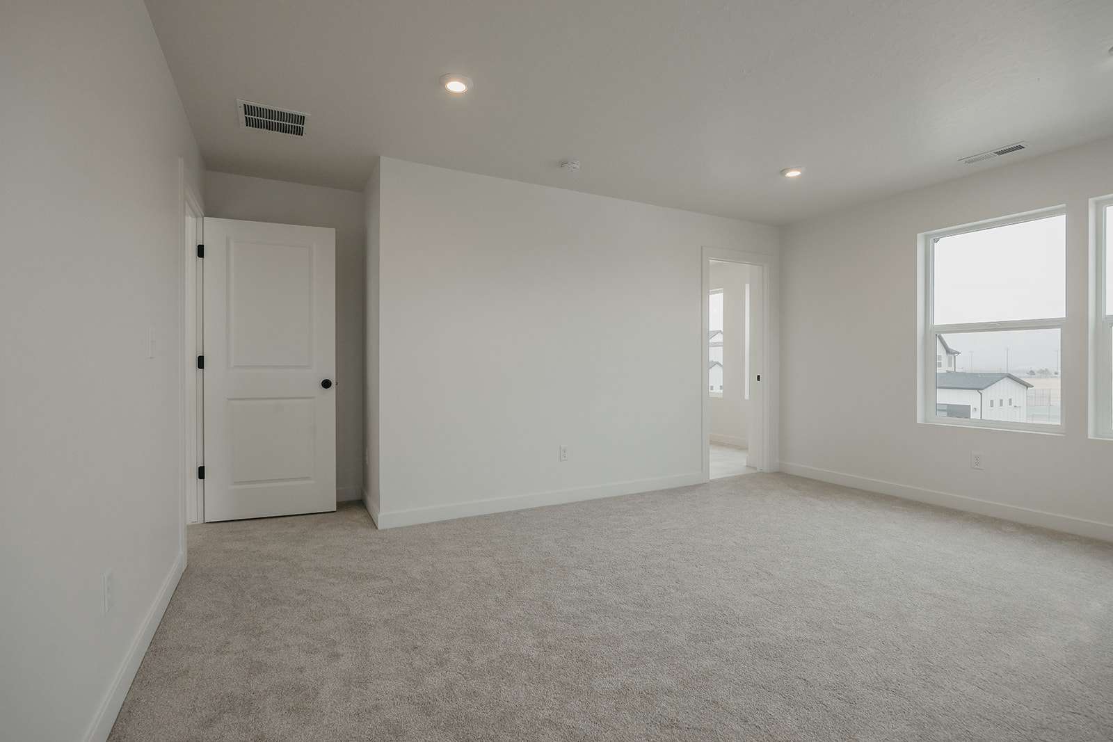 Unfurnished room with recessed lighting and light carpet