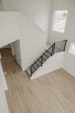 Stairway featuring wood finished floors and healthy amount of natural light