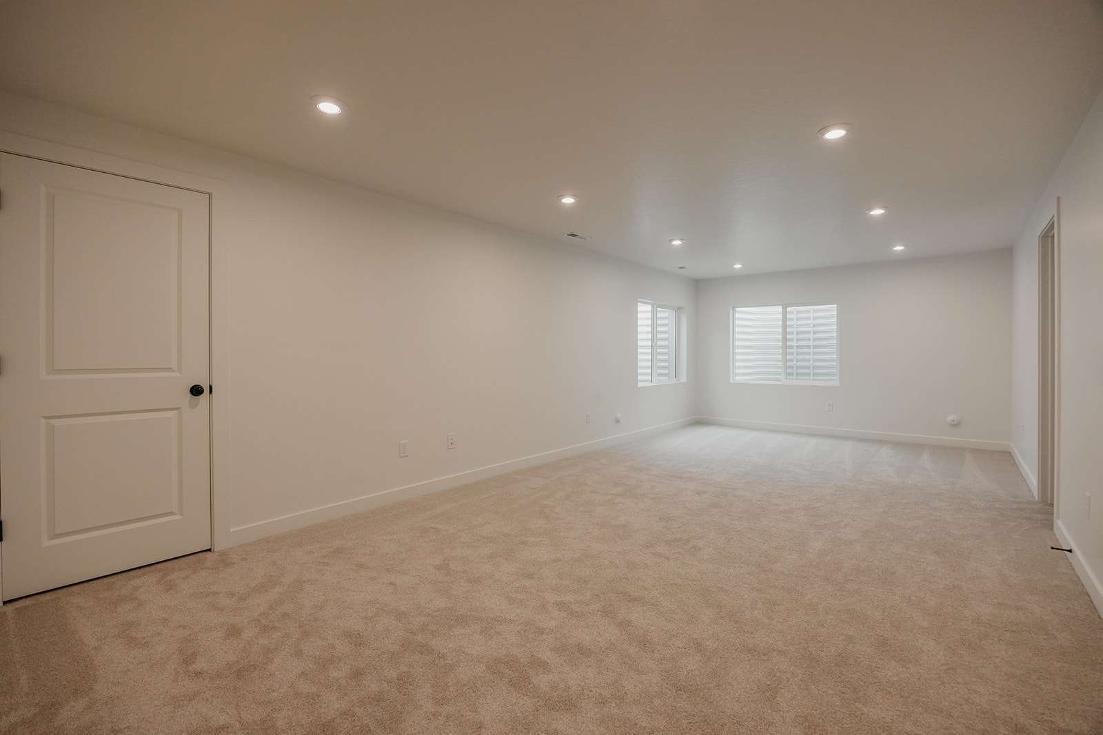 Spare room featuring recessed lighting and light colored carpet