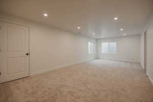 Spare room featuring recessed lighting and light colored carpet