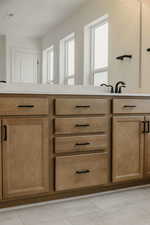 Bathroom featuring vanity and healthy amount of natural light