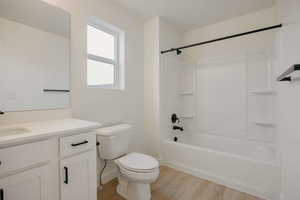 Full bathroom featuring vanity, light wood-type flooring, and shower / bath combination