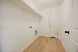 Laundry area featuring hookup for a washing machine, light wood-style flooring, and hookup for an electric dryer