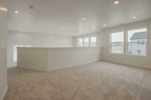 Empty room featuring light colored carpet and recessed lighting