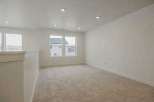 Empty room featuring light colored carpet and recessed lighting