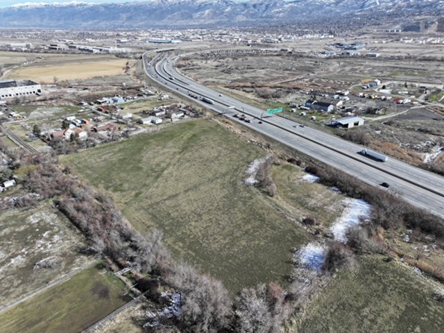 Aerial overview of property's location with a mountain backdrop and rural landscape