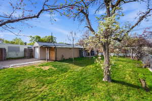 View of yard featuring a garage and driveway