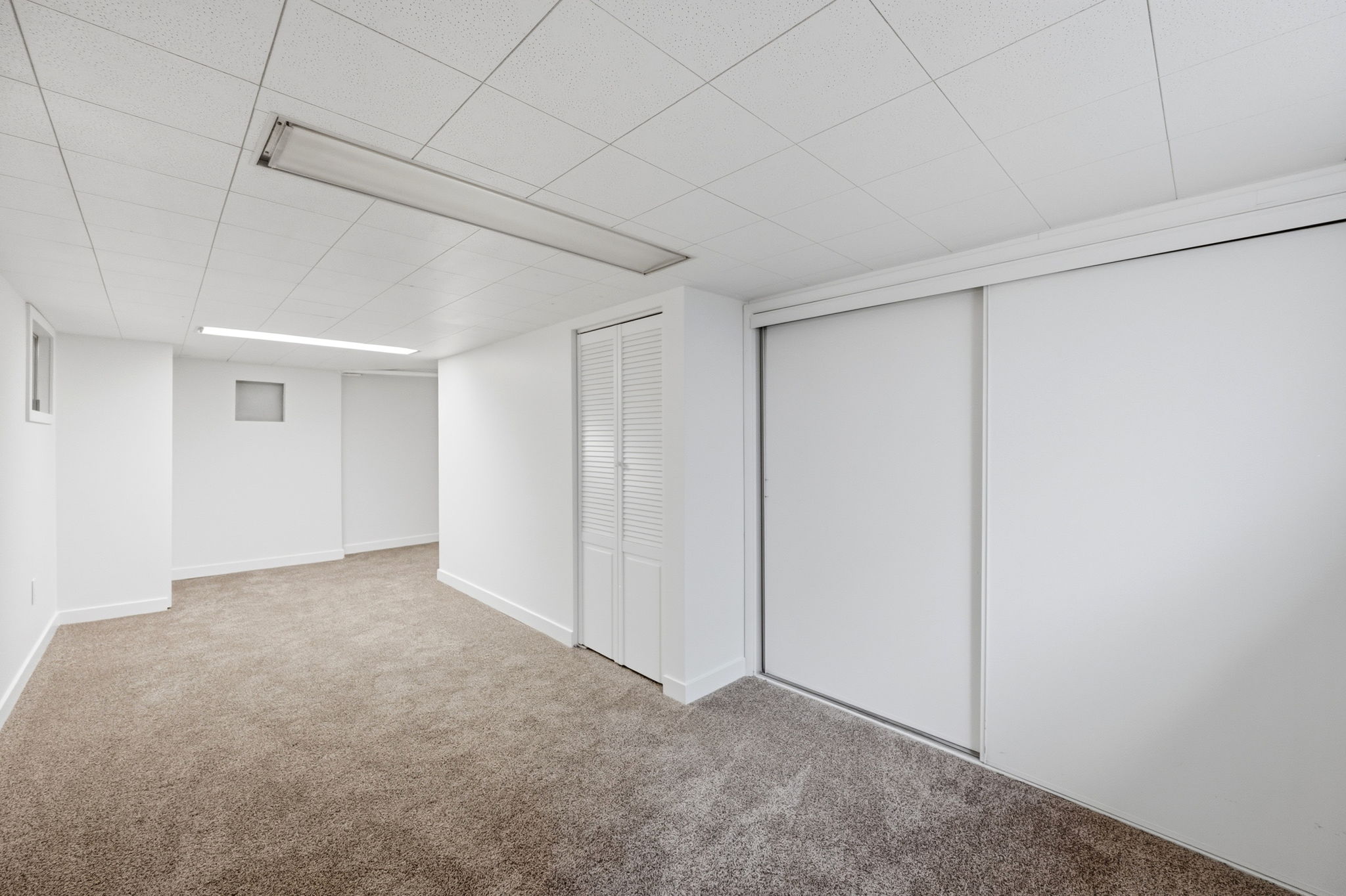 Finished basement featuring carpet flooring and baseboards