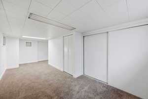 Finished basement featuring carpet flooring and baseboards