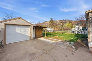 Garage with driveway and a mountain view