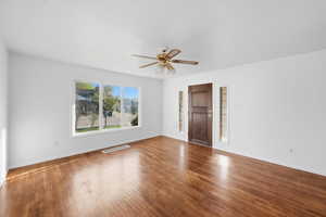 Unfurnished room with a ceiling fan and hardwood / wood-style flooring