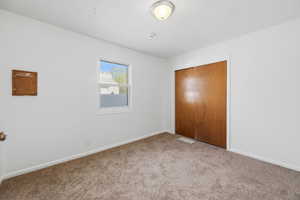 Unfurnished bedroom featuring a closet and carpet floors