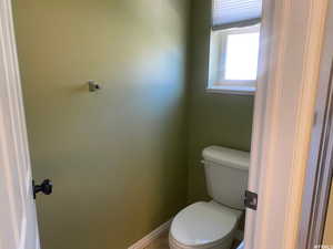 Bathroom with toilet and baseboards