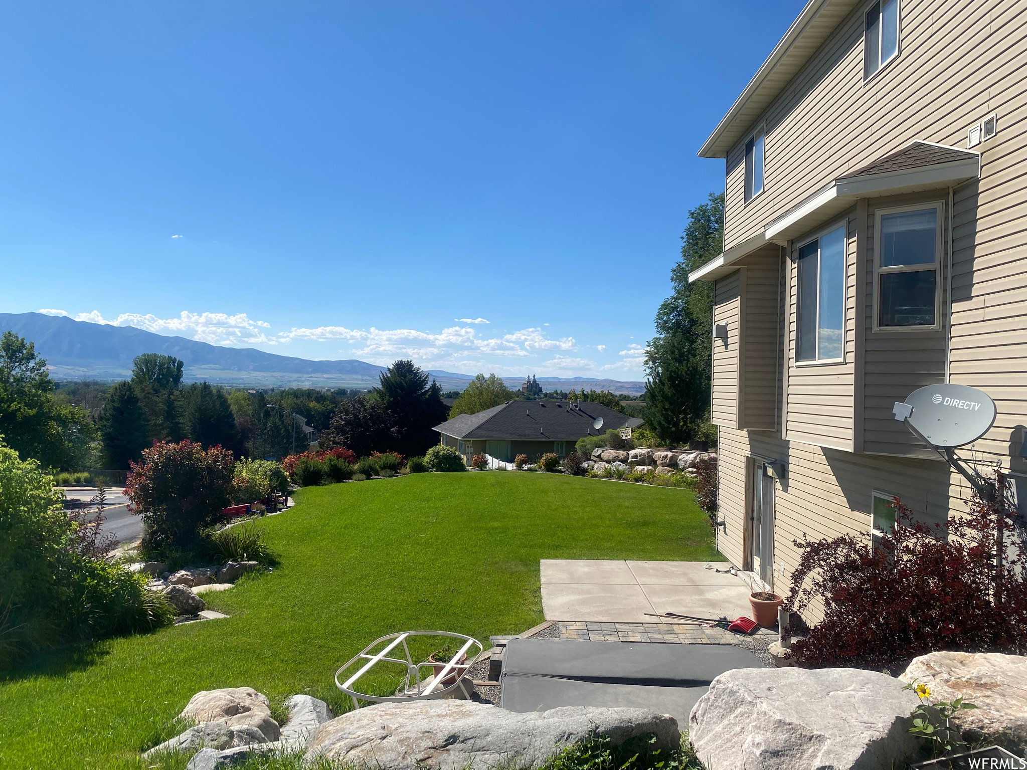View of green lawn featuring a mountain view
