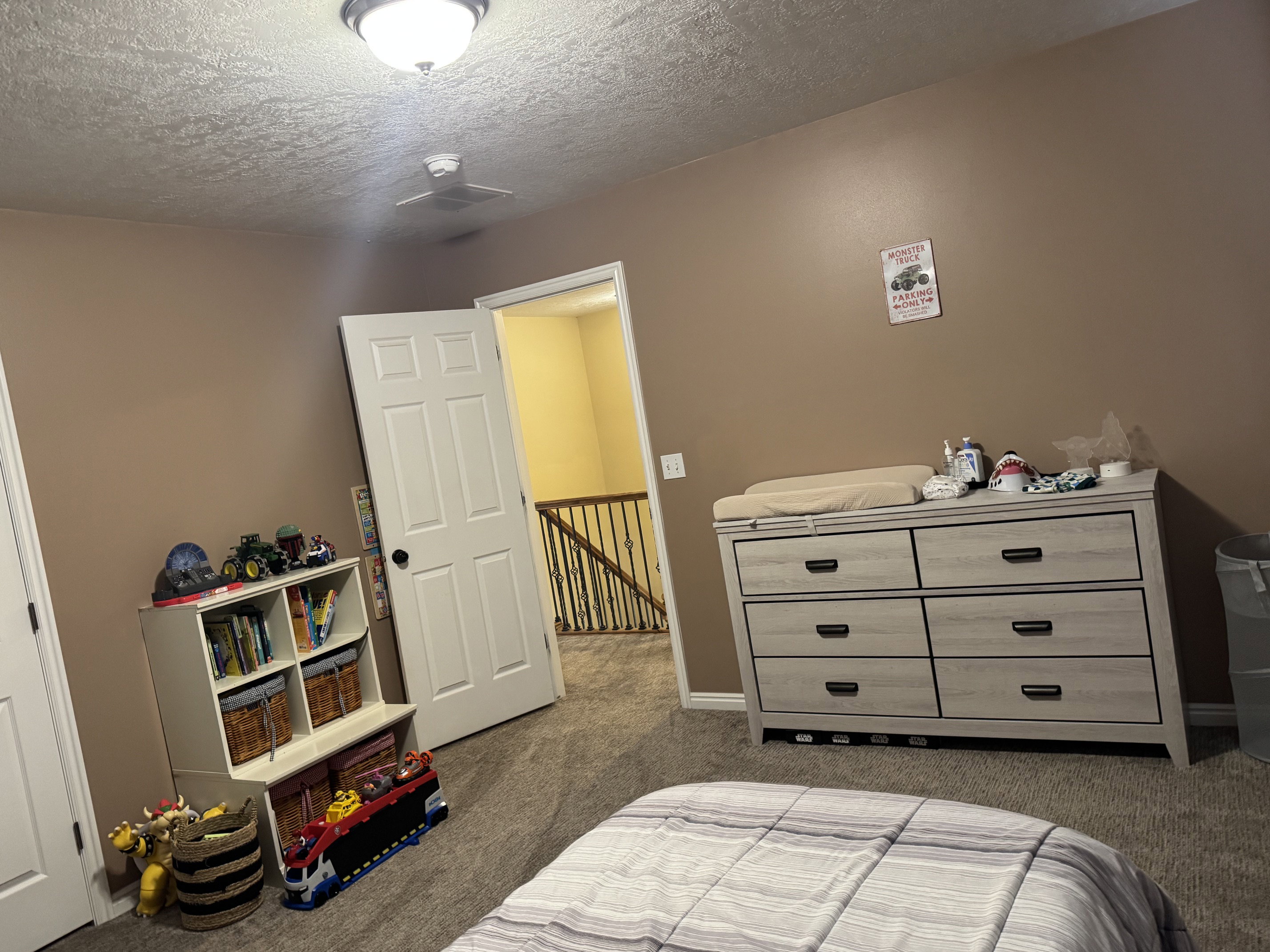 Carpeted room featuring a ceiling-mounted light fixture and neutral-toned walls