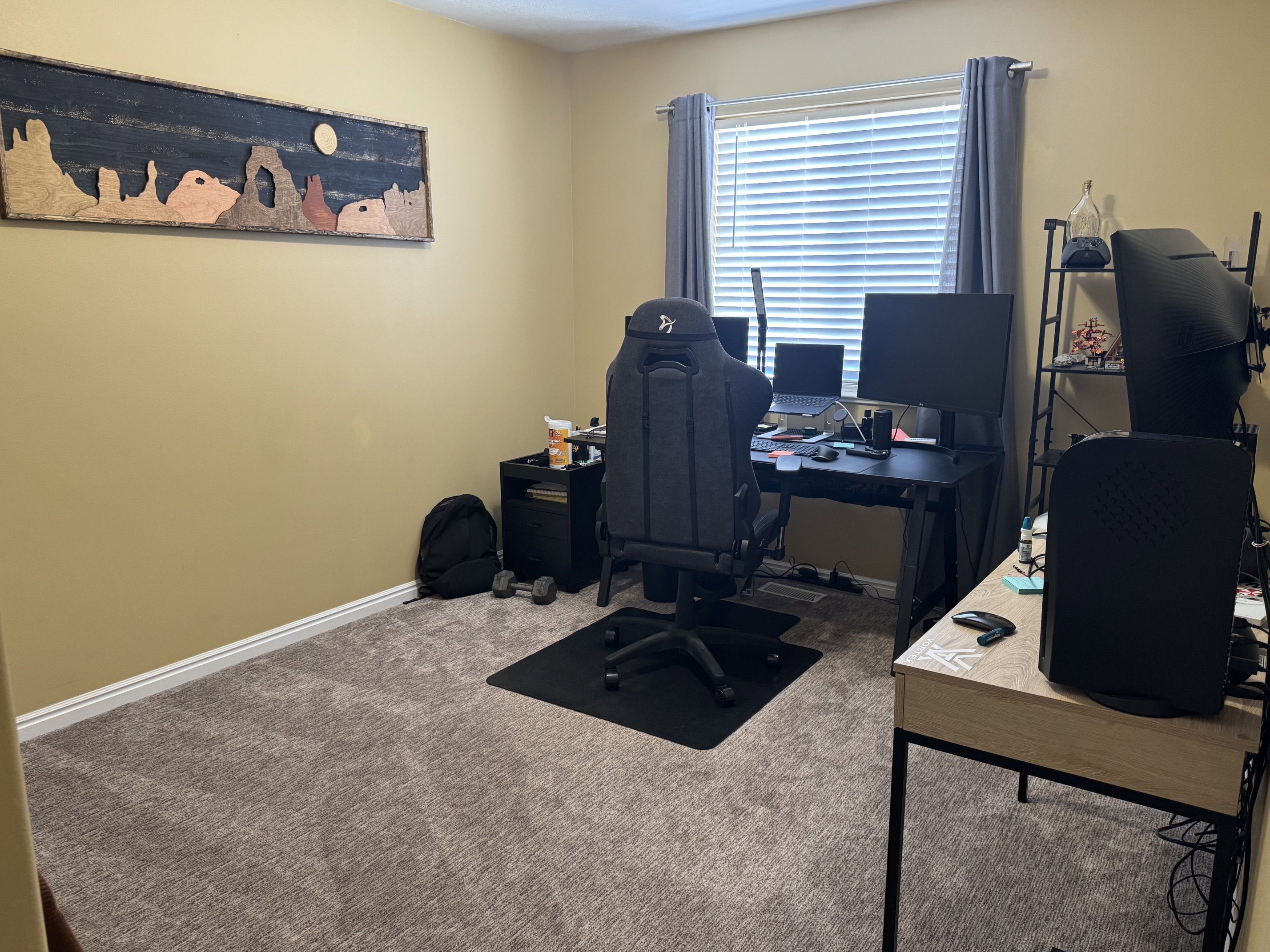 Carpeted room featuring a window with blinds, baseboard molding, and warm-toned wall paint