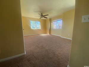 Unfurnished room featuring carpet floors and a ceiling fan