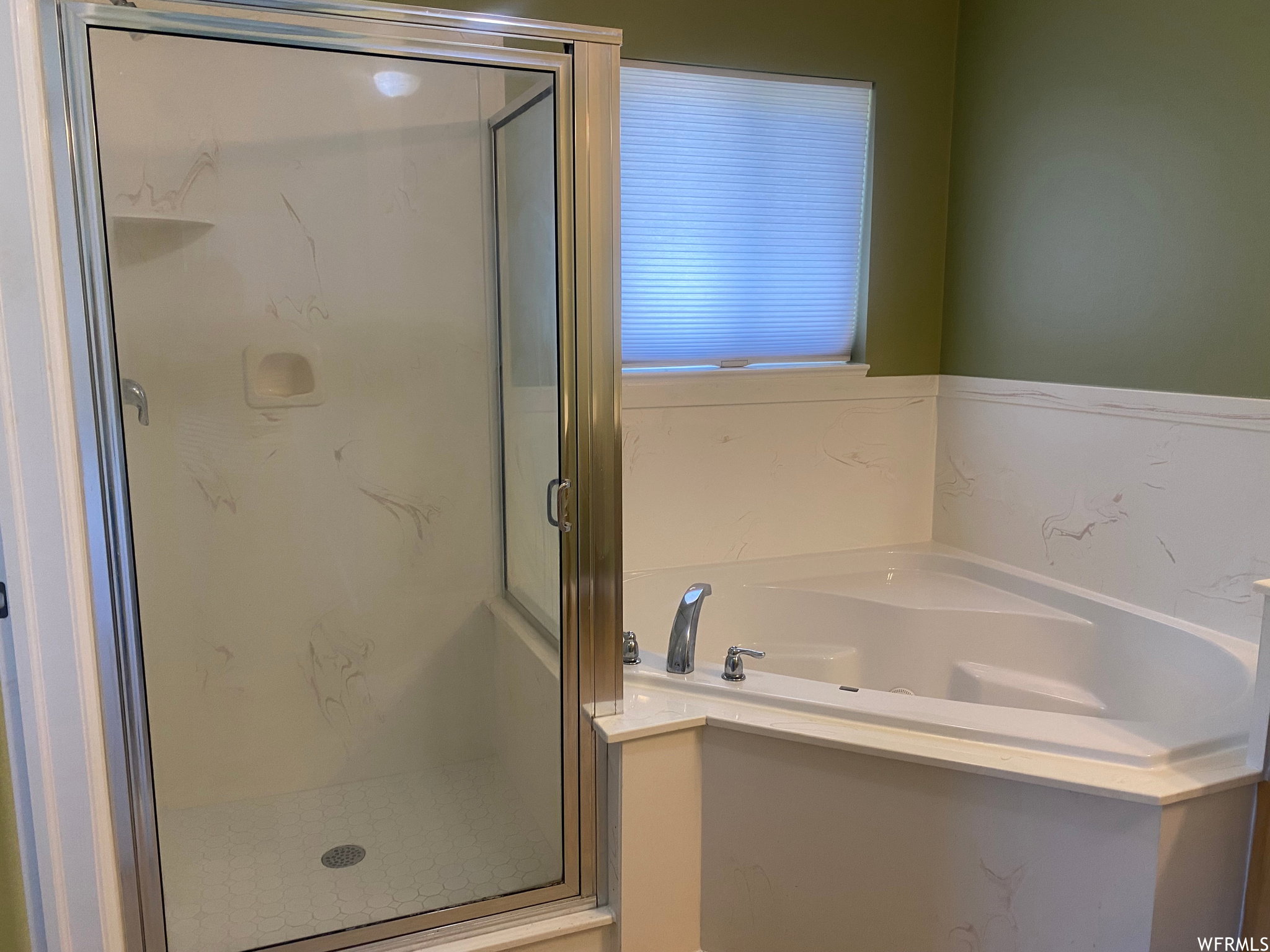 Full bath featuring a marble finish shower and a garden tub