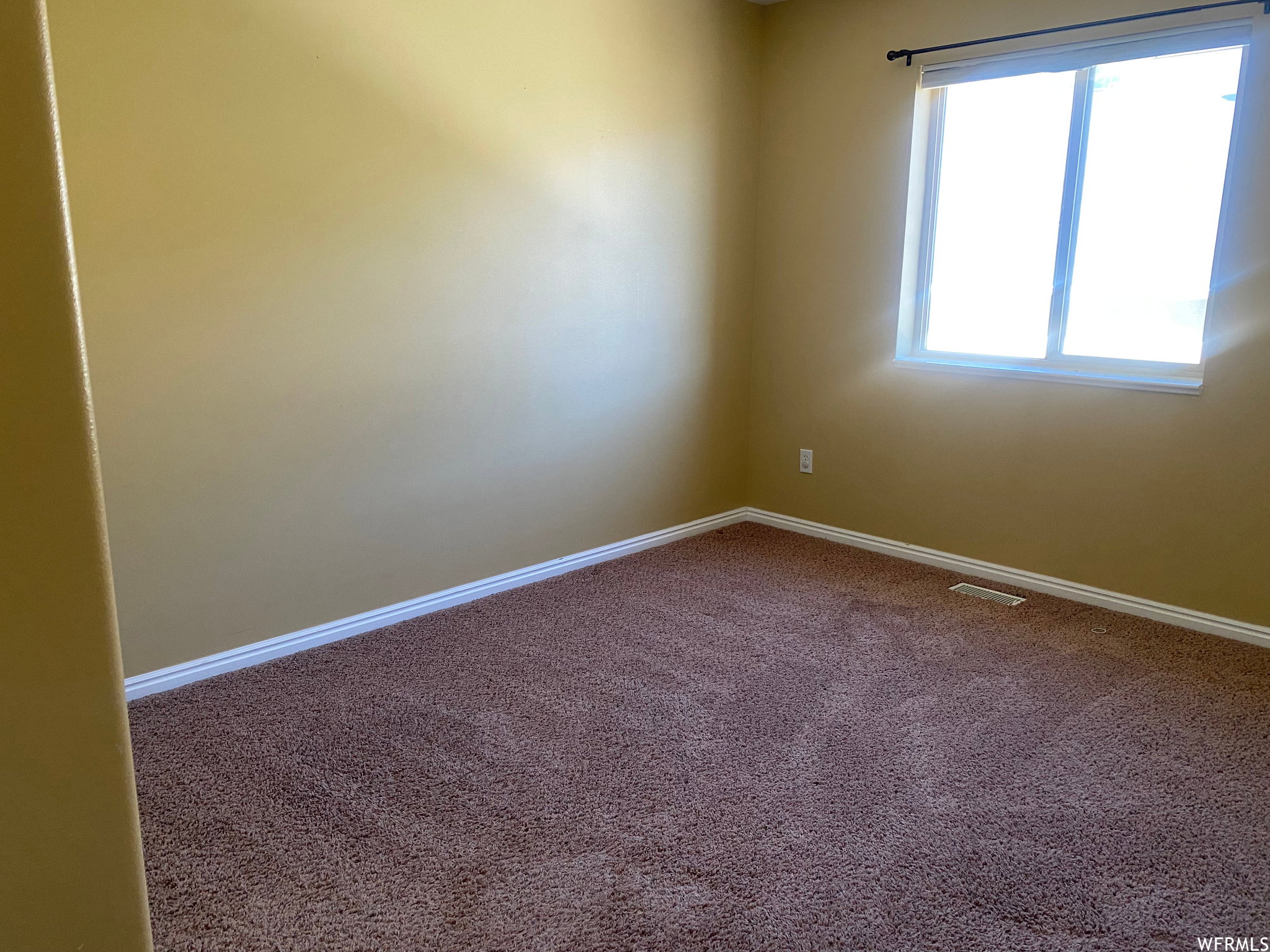Spare room with carpet flooring and baseboards