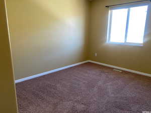 Spare room with carpet flooring and baseboards