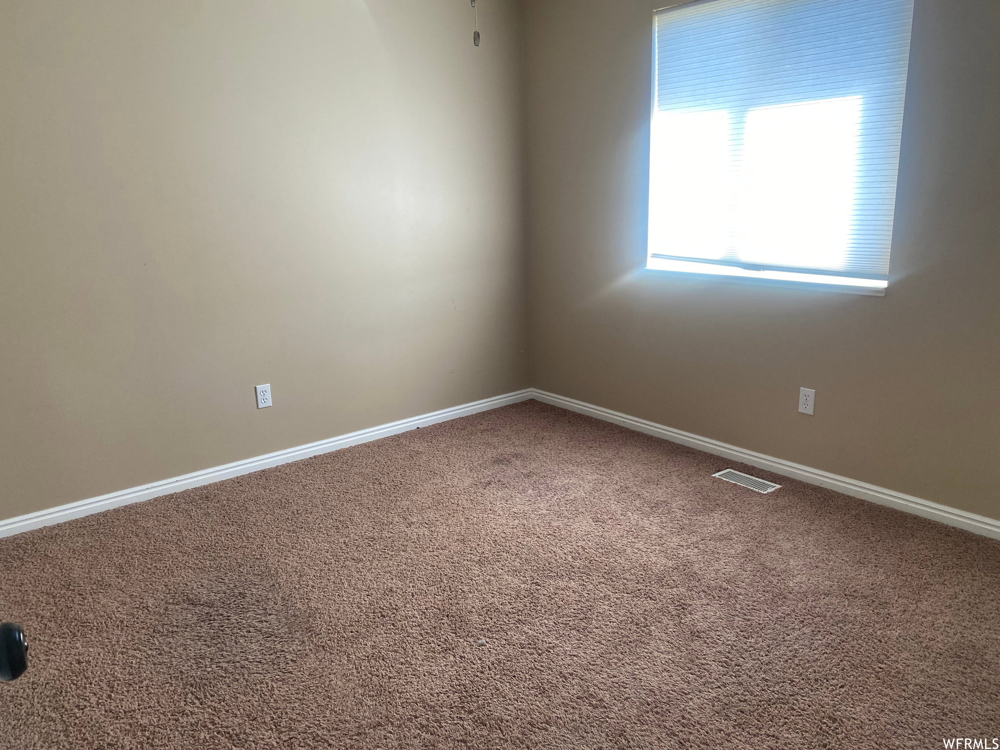 Spare room with carpet and baseboards